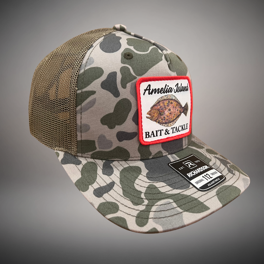 AIBT flounder patch trucker hat Richardson 112 in duck camo marsh - studio view