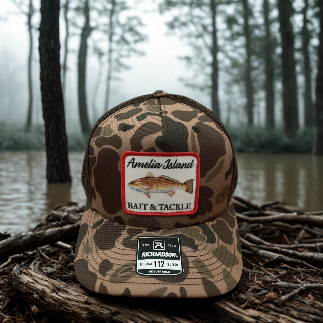 AIBT redfish patch trucker hat Richardson 112 in duck camo bark – hero view