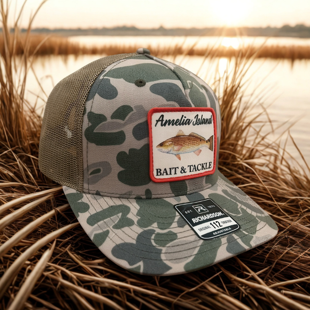 AIBT Redfish patch trucker hat Richardson 112 in duck camo marsh – hero view