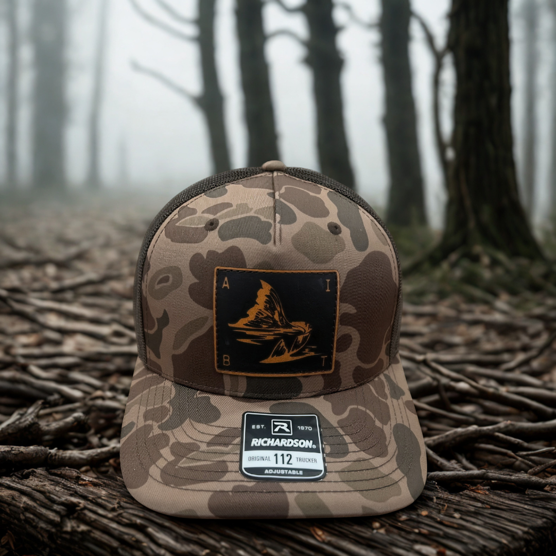 AIBT redfish tail leather patch trucker hat Richardson 112 in duck camo bark - hero view