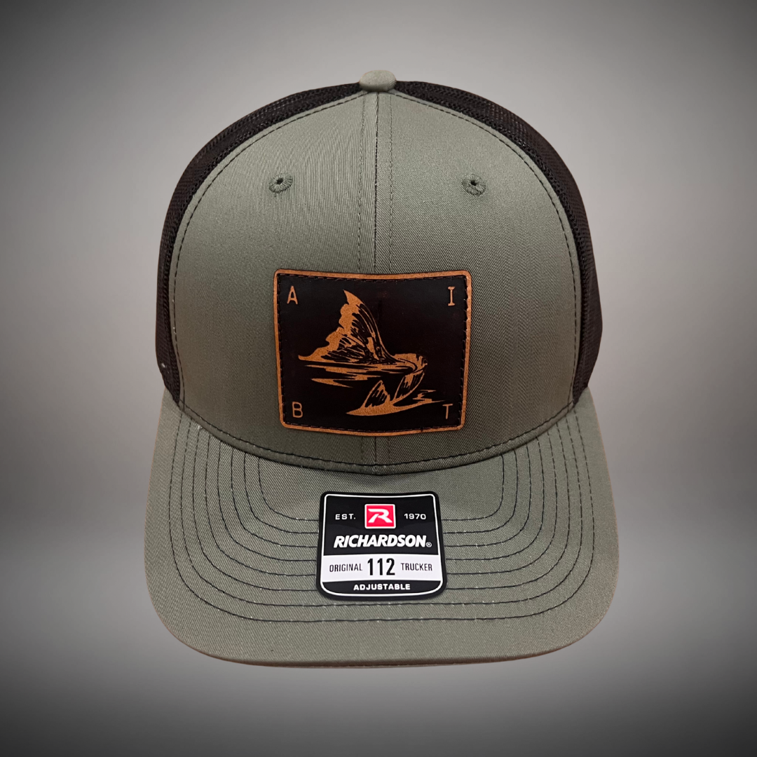 AIBT redfish tail leather patch trucker hat Richardson 112 in loden - studio view