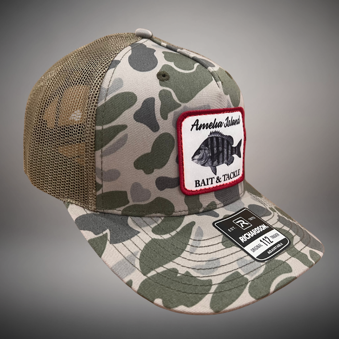 AIBT sheepshead patch trucker hat Richardson 112 in duck camo marsh - studio view