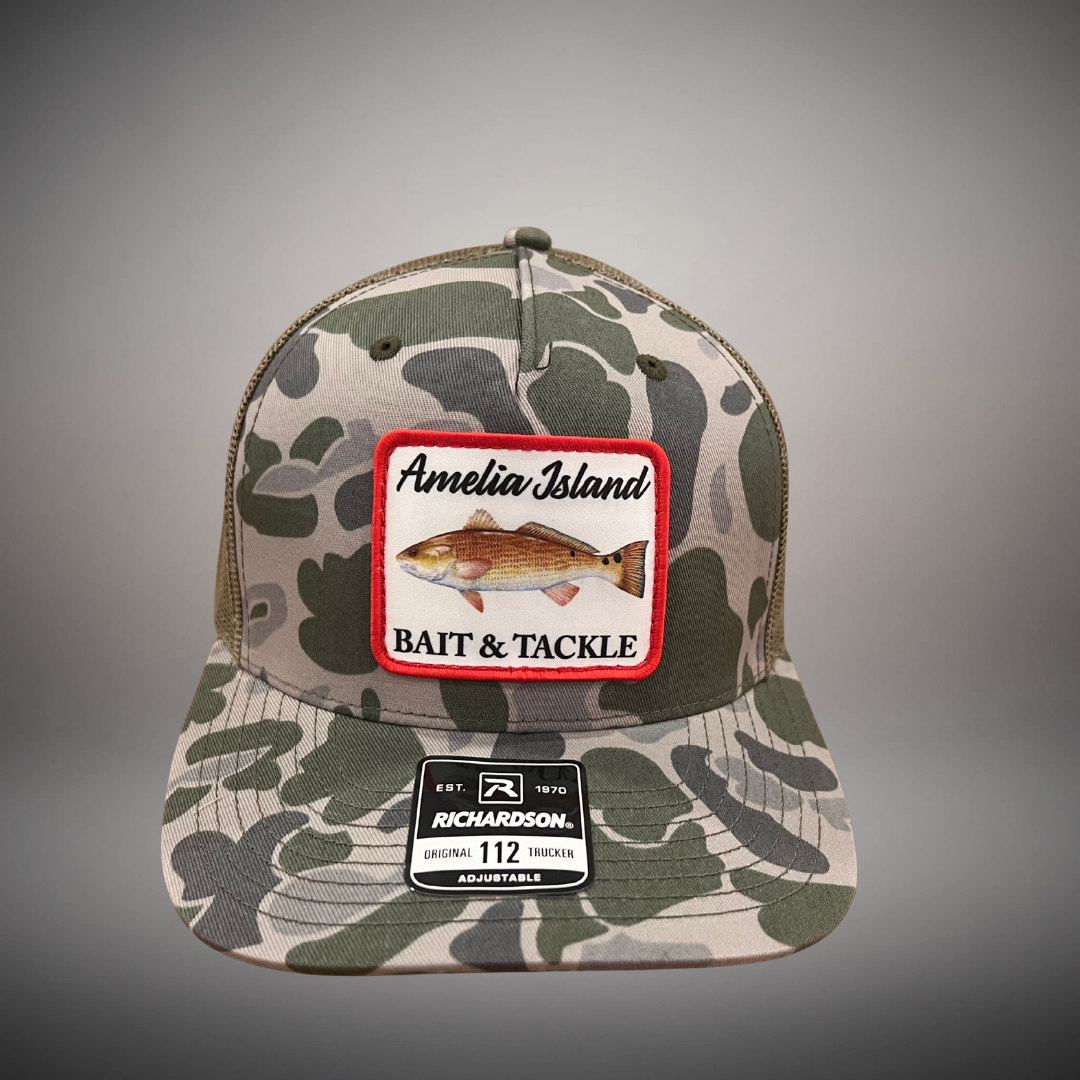 AIBT Redfish patch trucker hat Richardson 112 in duck camo marsh – studio view