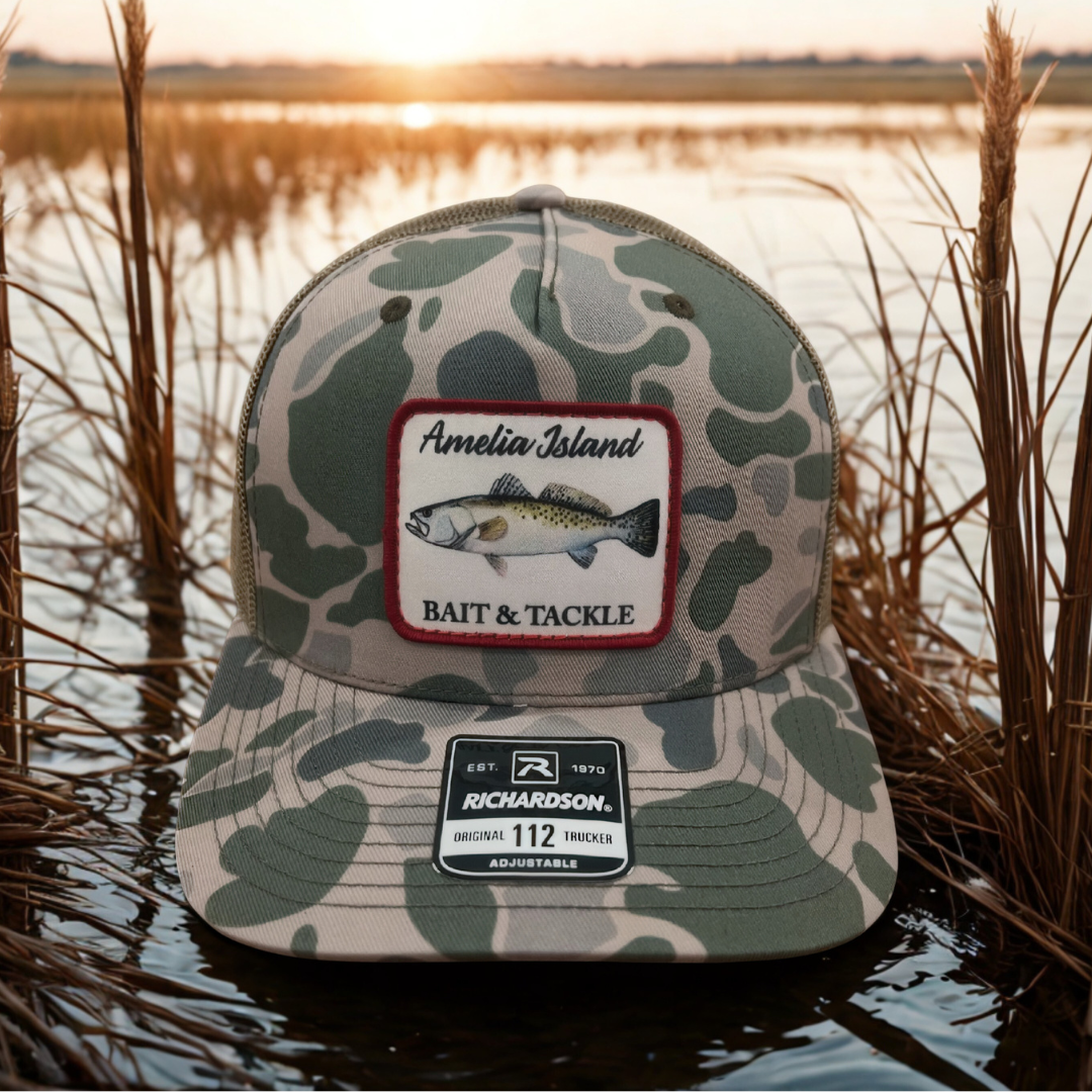 AIBT trout patch trucker hat Richardson 112 in duck camo marsh – hero view